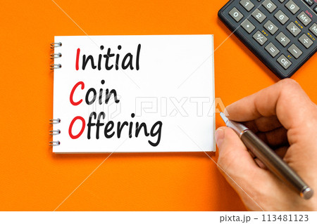 ICO initial coin offering symbol. Concept words ICO initial coin offering on beautiful white note. Beautiful orange background. Businessman hand. Business ICO initial coin offering concept. Copy space ICO initial coin offering symbol. Concept words ICO initial coin offering on beautiful white note. Beautiful orange background. Businessman hand. Business ICO initial coin offering concept. Copy space 113481123