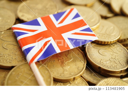 United Kingdom flag on coin and banknote money, finance trading investment business currency concept. United Kingdom flag on coin and banknote money, finance trading investment business currency concept. 113481905