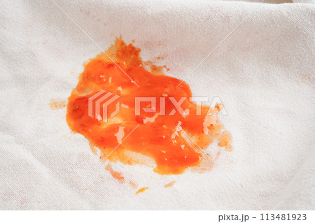 Dirty tomato sauce stain or ketchup on cloth to wash with washing powder, cleaning housework concept. 113481923