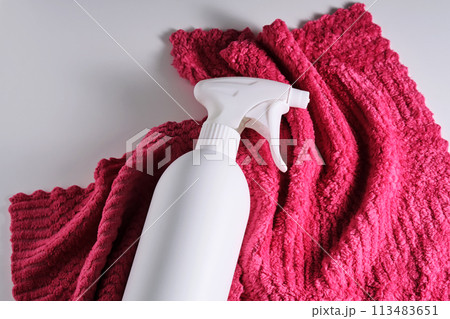 Cleaning product with a sprayer on a background of a red microfiber cloth. Cleaning product with a sprayer on a background of a red microfiber cloth. 113483651