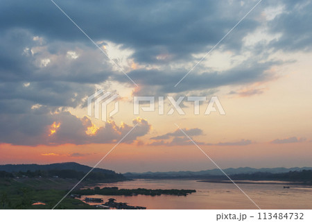 Silhouette tranquil season wilderness serene landscape. Tranquil lake countryside sunrise seaside reflection. Tropical amazing dramatic golden sky on sunset over scenic river lake seascape ocean. 113484732