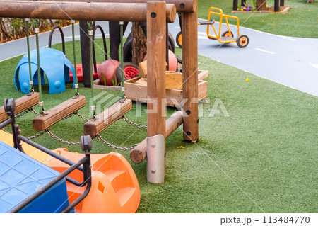 Empty playground with various equipment and toys on green synthetic grass 113484770