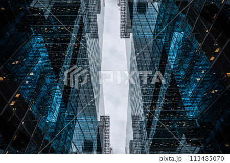 symmetry and mirrored geometry pattern, reflected skyscrapers and modern buildings abstract background, lines and tunnel futuristic technology concept 113485070