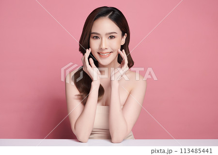 Beautiful young asian woman with clean fresh skin on pink background, Face care, Facial treatment, Cosmetology, beauty and spa, Asian women portrait. 113485441