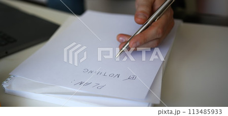Male hand hold silver pen composing to do list 113485933
