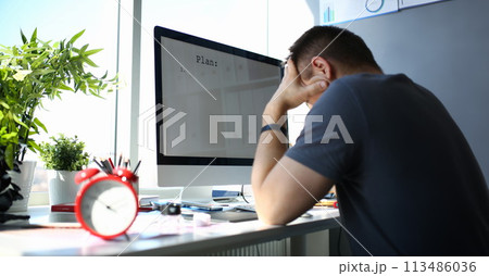 Sad upset male worker hold his head solving business problem 113486036
