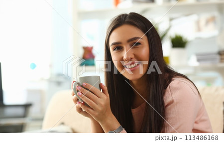 Indian woman holds mug her hand smiles Indian woman holds mug her hand smiles 113486168