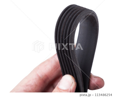 V-ribbed engine belt made of black rubber on a white isolated background in a photo studio of auto parts for replacement during repair or for a catalog of spare parts for sale on auto analysis. V-ribbed engine belt made of black rubber on a white isolated background in a photo studio of auto parts for replacement during repair or for a catalog of spare parts for sale on auto analysis. 113486254