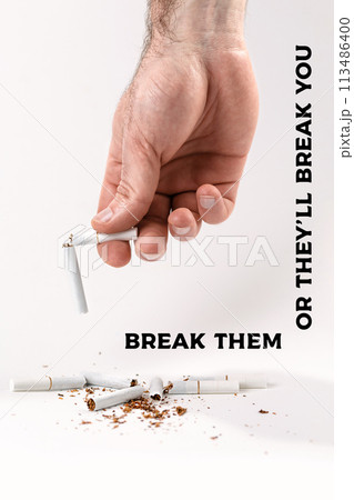The concept of nicotine addiction and anti-Smoking. A man's hand holds a cigarette broken in half, at the bottom are the fragments of cigarettes. White background. Break them or they'll break you The concept of nicotine addiction and anti-Smoking. A man's hand holds a cigarette broken in half, at the bottom are the fragments of cigarettes. White background. Break them or they'll break you 113486400