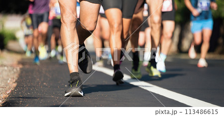 Marathon running race, people feet on city road 113486615