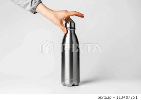Hand Holding a Stainless Steel Water Bottle. Generative ai 113487251