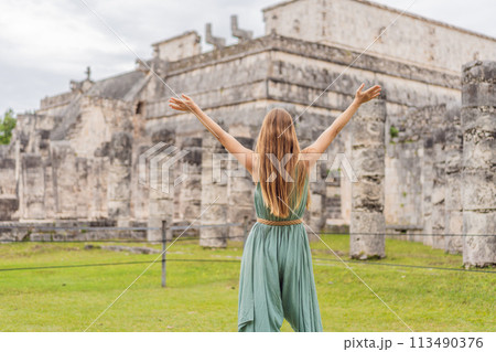 Beautiful tourist woman observing the old pyramid and temple of the castle of the Mayan architecture known as Chichen Itza these are the ruins of this ancient pre-columbian civilization and part of 113490376