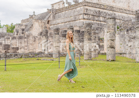 Beautiful tourist woman observing the old pyramid and temple of the castle of the Mayan architecture known as Chichen Itza these are the ruins of this ancient pre-columbian civilization and part of 113490378