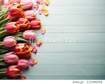 Beautiful tulips on light blue wooden background, top view. Space for text 113490856
