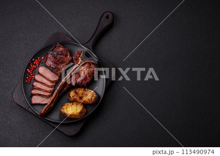 Delicious juicy beef tbone steak with salt, spices and herbs Delicious juicy beef tbone steak with salt, spices and herbs 113490974