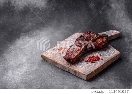 Delicious juicy beef tbone steak with salt, spices and herbs Delicious juicy beef tbone steak with salt, spices and herbs 113491037