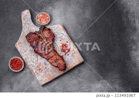 Delicious juicy beef tbone steak with salt, spices and herbs Delicious juicy beef tbone steak with salt, spices and herbs 113491067