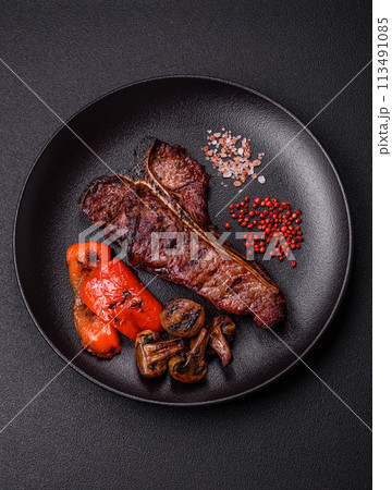 Delicious juicy beef tbone steak with salt, spices and herbs 113491085