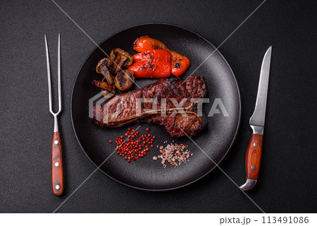 Delicious juicy beef tbone steak with salt, spices and herbs Delicious juicy beef tbone steak with salt, spices and herbs 113491086