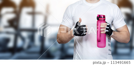 Fitness athlete shows well with hand . Fitness athlete shows well with hand . 113491665