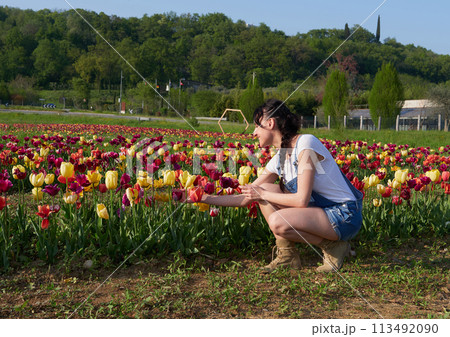 happy female workers trimming flowers in greenhouse happy female workers trimming flowers in greenhouse 113492090