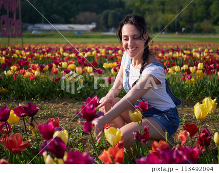 happy female workers trimming flowers in greenhouse 113492094