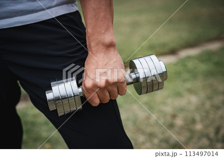 公園でダンベルで筋力トレーニングをする40代男性 113497014