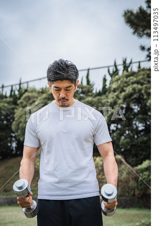 公園でダンベルで筋力トレーニングをする40代男性 公園でダンベルで筋力トレーニングをする40代男性 113497035