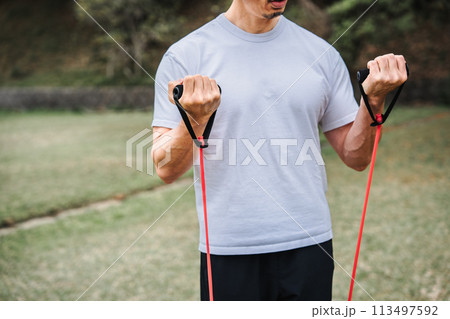 公園でトレーニングチューブで筋トレをする40代男性 公園でトレーニングチューブで筋トレをする40代男性 113497592