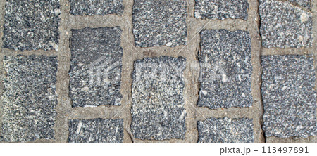 An old wall piled of gray stone blocks. An old wall piled of gray stone blocks. 113497891