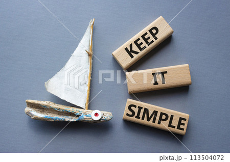Keep it Simple symbol. Concept words Keep it Simple on wooden blocks. Beautiful grey background with boat. Business and Keep it Simple concept. Copy space. Keep it Simple symbol. Concept words Keep it Simple on wooden blocks. Beautiful grey background with boat. Business and Keep it Simple concept. Copy space. 113504072