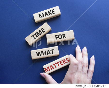 Important thing symbol. Wooden blocks with words Make time for what matters. Businessman hand. Beautiful deep blue background. Business and important thing concept. Copy space. Important thing symbol. Wooden blocks with words Make time for what matters. Businessman hand. Beautiful deep blue background. Business and important thing concept. Copy space. 113504216