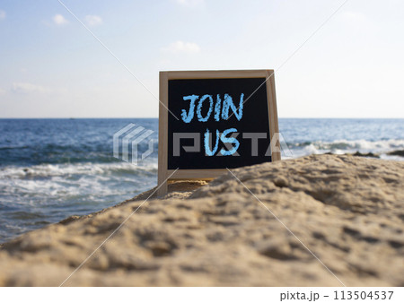 Join us symbol. Concept word Join us on black chalk background. Beautiful sea background. Business and Join us concept. Copy space 113504537