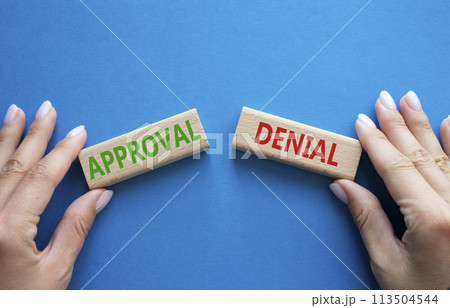 Approval or Denial symbol. Concept word Approval or Denial on wooden blocks. Businessman hand. Beautiful blue background. Business and Approval or Denial concept. Copy space 113504544