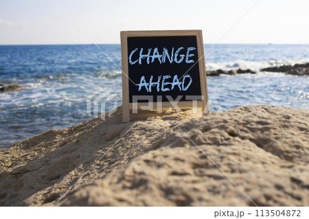 Change ahead symbol. Concept word Change ahead on black chalk background. Beautiful sea background. Business and Change ahead concept. Copy space Change ahead symbol. Concept word Change ahead on black chalk background. Beautiful sea background. Business and Change ahead concept. Copy space 113504872