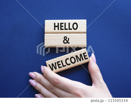 Hello and Welcome symbol. Concept words Hello and Welcome on wooden blocks. Beautiful deep blue background. Businessman hand. Business and Hello and Welcome concept. Copy space. Hello and Welcome symbol. Concept words Hello and Welcome on wooden blocks. Beautiful deep blue background. Businessman hand. Business and Hello and Welcome concept. Copy space. 113505319