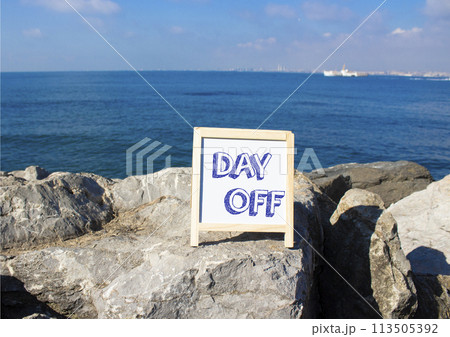 Day off symbol. Day off white chalk blackboard. Beautiful sea background. Business and Day off concept. Copy space. 113505392