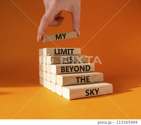 My limit is beyond the sky symbol. Wooden blocks with words My limit is beyond the sky. Beautiful orange background. Businessman hand. Business concept. Copy space. 113505994
