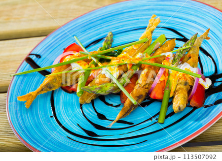 Fried in batter sprats with creamy ginger sauce, tomatoes, balsamic paste 113507092