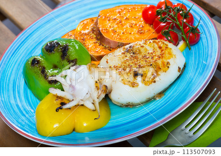 Sepia fried on a grill with Bulgarian pepper and boiled batat is tasty dish 113507093