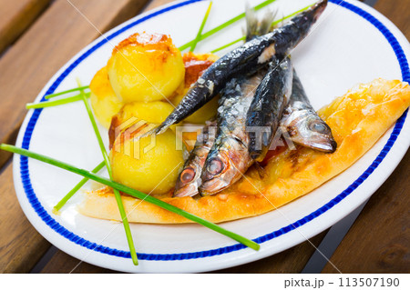 Deliciously fried sprats with scone and potato croquettes on plate 113507190