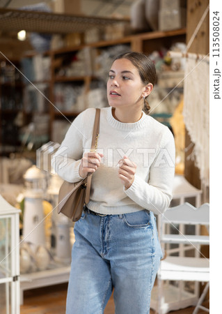 Young woman choosing furniture in store 113508024
