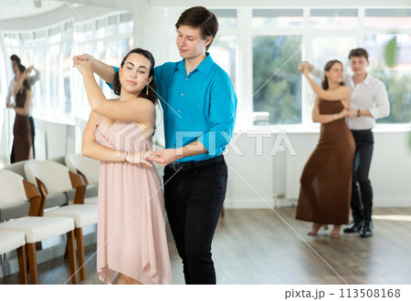 During rehearsal, guy and girl participants of dance workshop perform social pair dance During rehearsal, guy and girl participants of dance workshop perform social pair dance 113508168