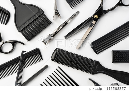 Black hairdressing tools and various hairbrushes on white background 113508277