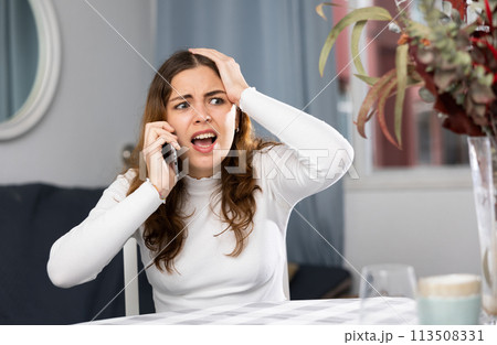 Angry woman arguing while having telephone conversation 113508331