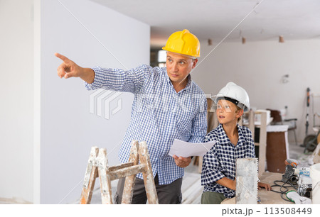 Father and son talking about space planning in new apartment 113508449