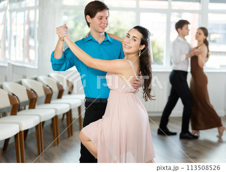 Young brunette practicing sensual bachata with guy in dance class 113508526