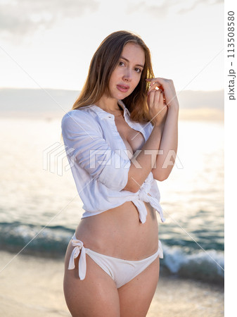 Portrait of sensual young lady enjoying warm, tropical ocean water 113508580