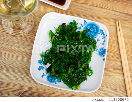 Goma Wakame salad served in a plate with soy sauce Goma Wakame salad served in a plate with soy sauce 113508676