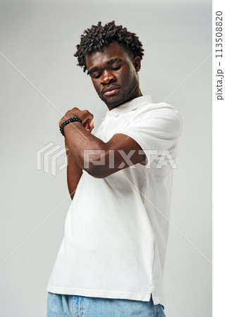 A man is standing and posing for a picture, with his fist raised in the air. 113508820
